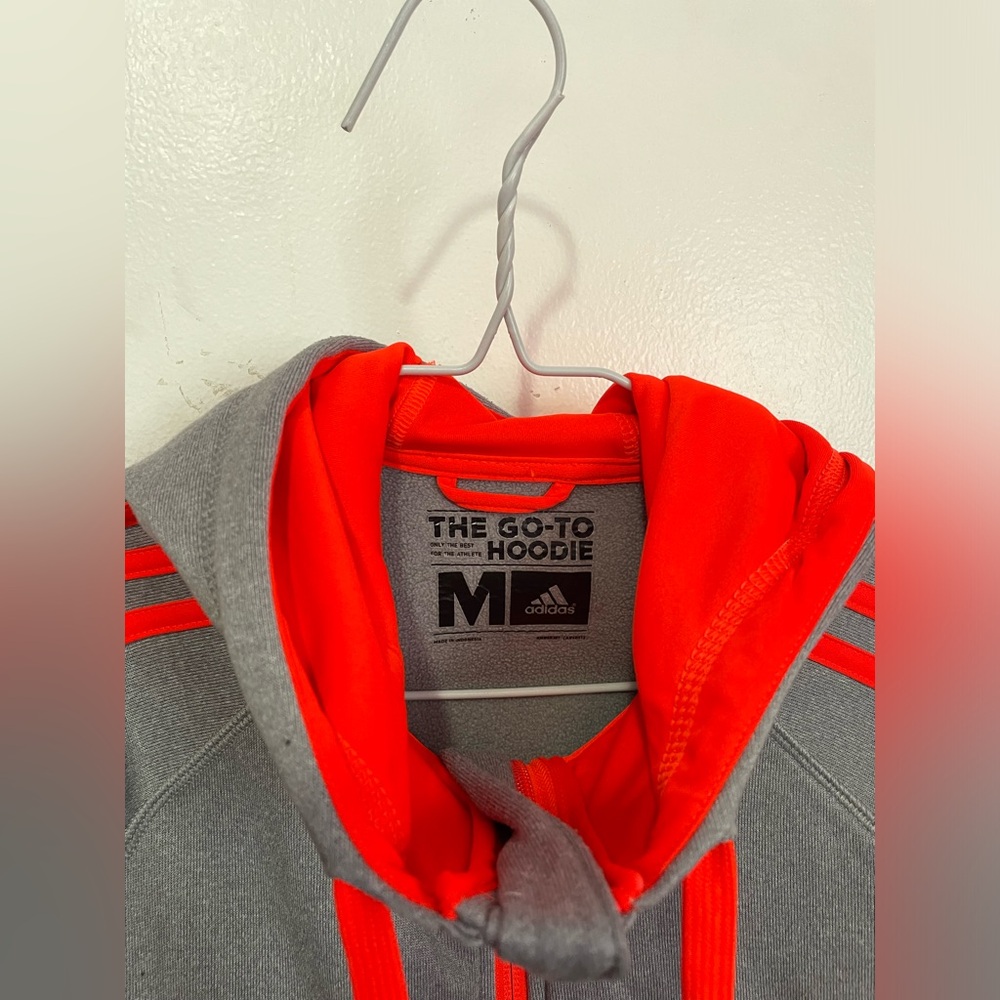 Adidas grey & orange zip up hoodie. Soft lining with warmth for the winter.